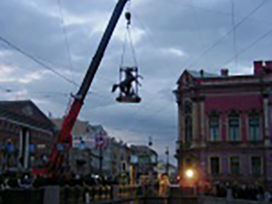 crane lifting horse statue
